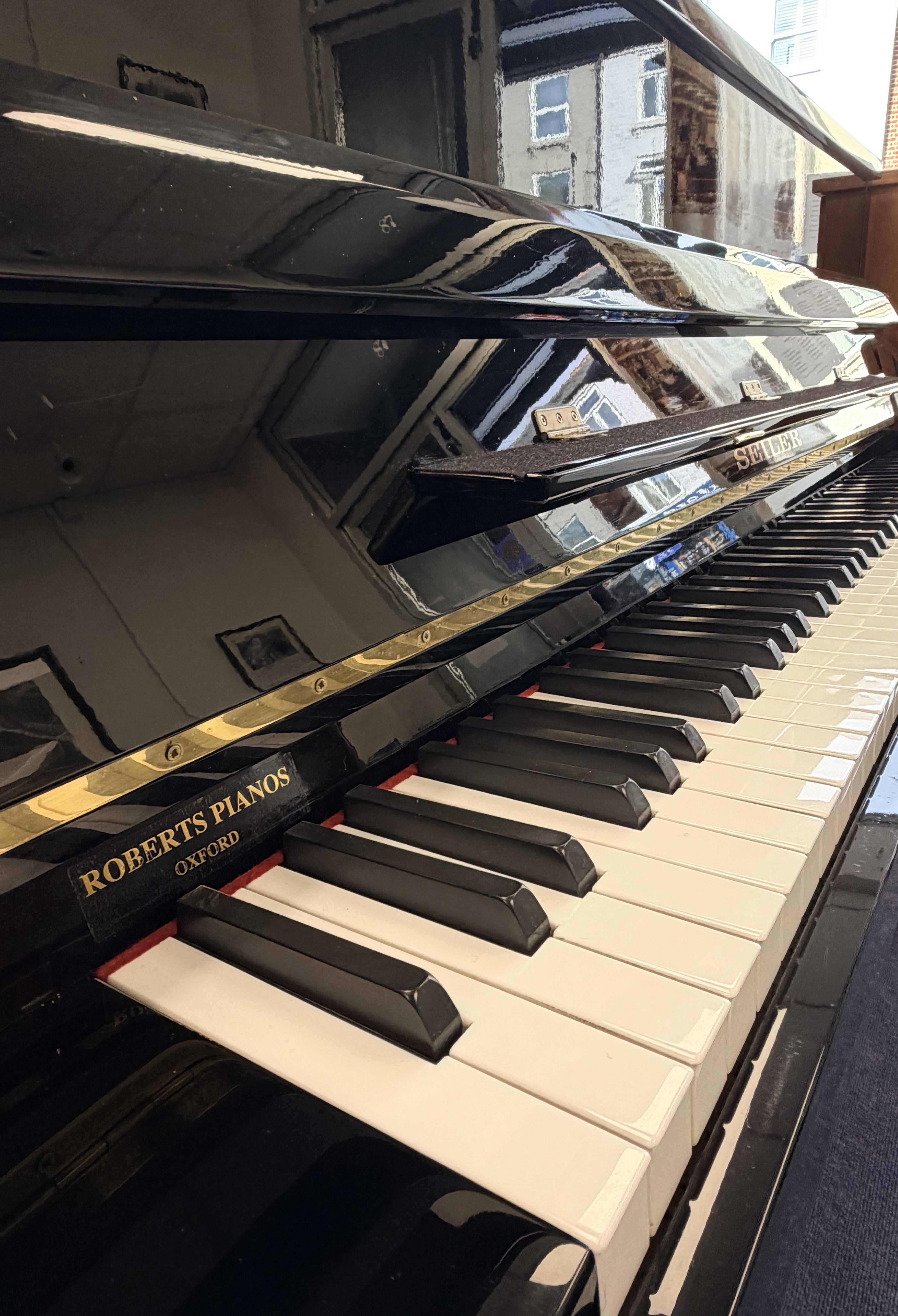 Seiler 116 Upright Piano in Black Polyester – Gallery image – Roberts Pianos Oxford