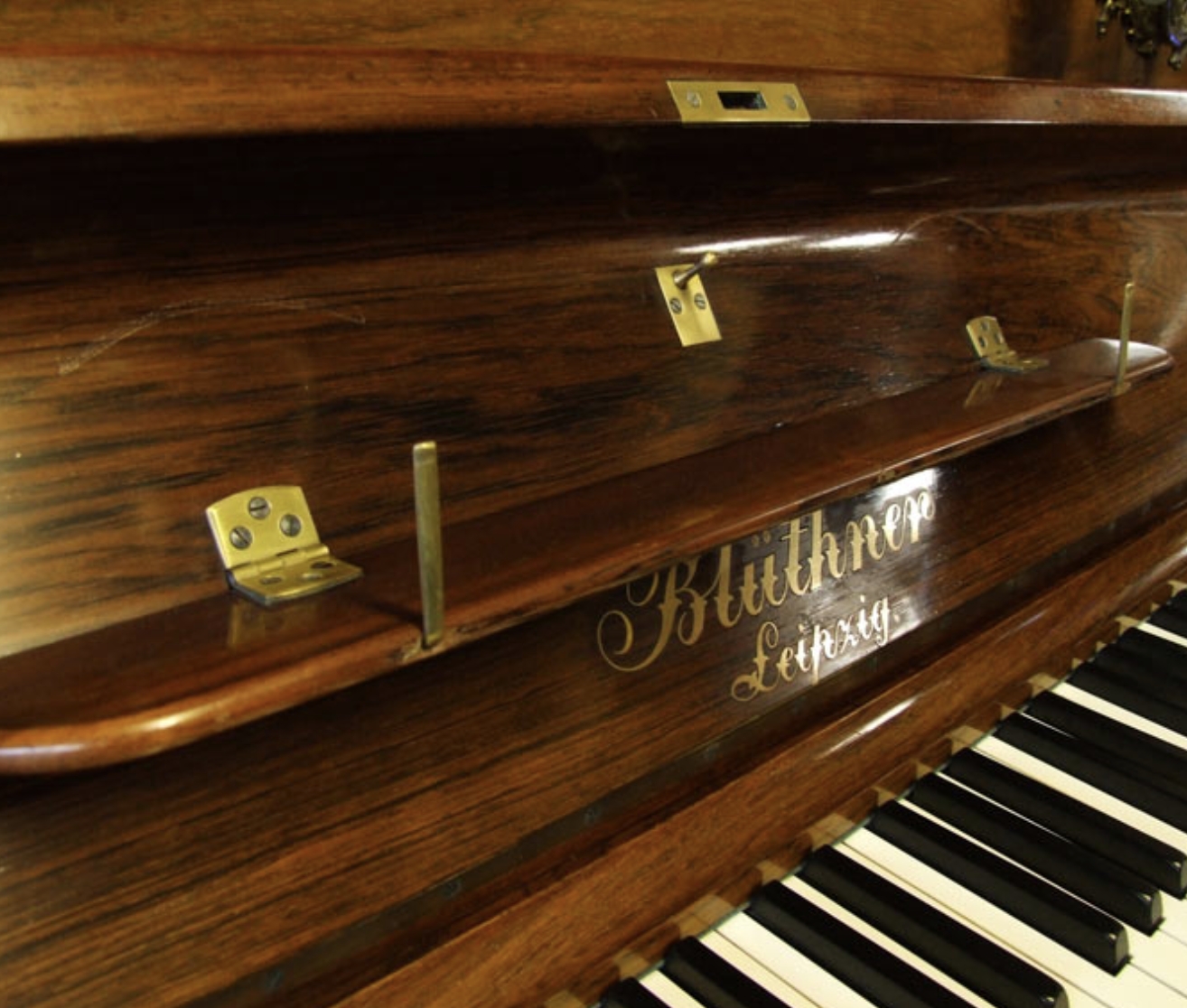 Bluthner upright Piano in rosewood with sconces – Gallery image – Roberts Pianos Oxford