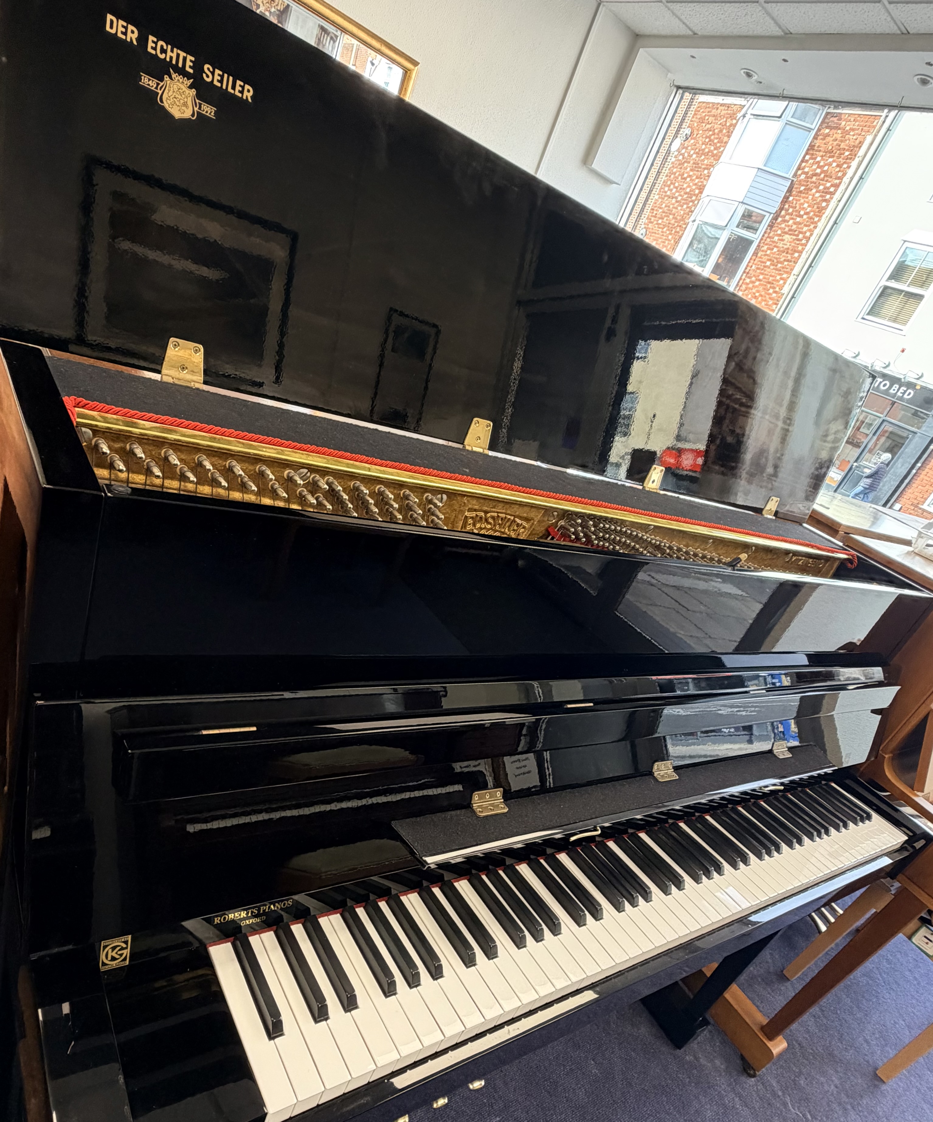 Seiler 116 Upright Piano in Black Polyester – Gallery image – Roberts Pianos Oxford